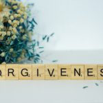 a scrabble type block spelling out the word forgiveness