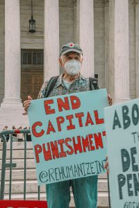 a man holding a sign in front of a building