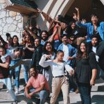 standing and sitting of people taking group photo