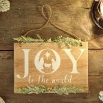 a wooden sign that says joy to the world
