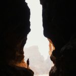 a person standing in the middle of a cave