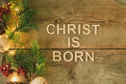 a picture of a christmas wreath with the words christ is born