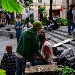 A group of people sitting on the steps of a building