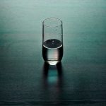 clear drinking glass on brown wooden surface