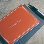 fountain pen next to red Thank You journal