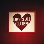 a picture of a heart on a wall with the words love is all you need