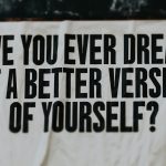 A white sign with black writing on it