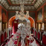 a fancy dining room with a chandelier hanging from the ceiling