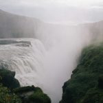 waterfalls on green grass covered mountain during daytime
