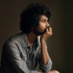 man in gray and white checkered dress shirt